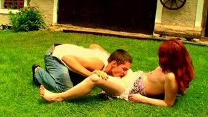 Filthy redhead whore is fucking with her partner on the grass